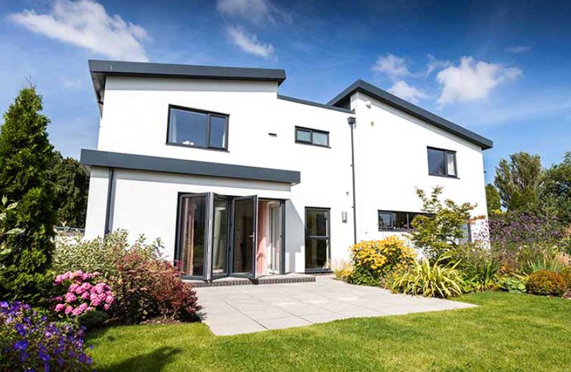 Open bifold doors on a white house