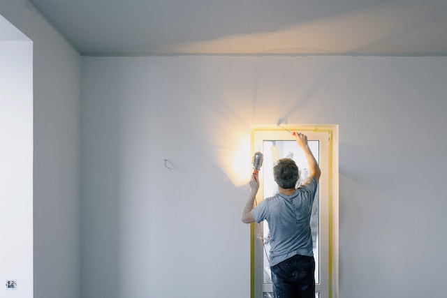 Man repairing a door frame